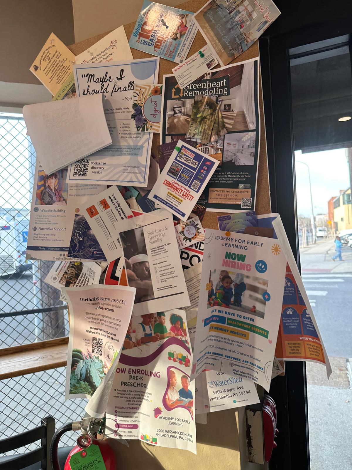 Cluttered paper noticeboard inside a local business, example 3